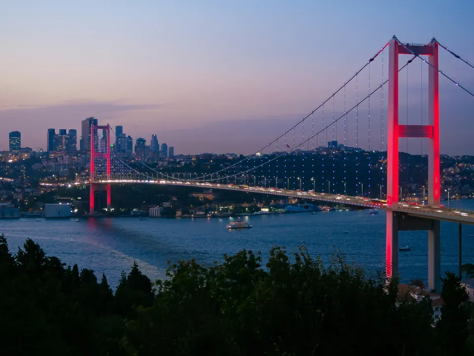 15 July Martyrs (Bosphorus) Bridge lit at dusk with the Istanbul skyline